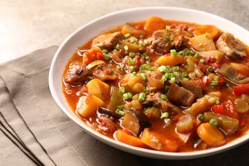 Delicious stew with vegetables in bowl on table, closeup