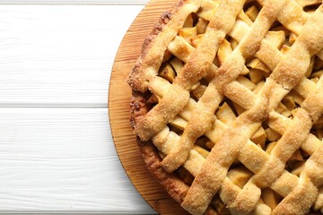 Tasty homemade apple pie on white wooden table, top view. Space for text