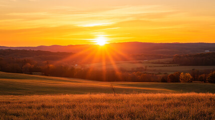 Fototapeta premium Golden sunset over a serene landscape, with trees silhouetted against a vibrant sky in autumn colors during late afternoon