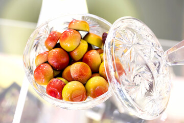 Closeup of colored handmade chocolate candies filled with orange and mango cream.