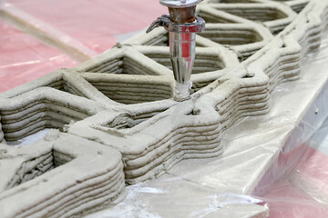 The 3d printer prints a wall for a house at a construction fair.