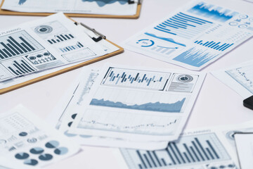 Piles of business intelligence paper or BI financial report and financial data visualization on paperwork for business analytic marketing and strategic planning at office desk. Prudent