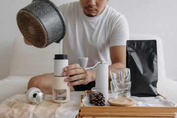 Step by step of Asian man making espresso with hand press tools.