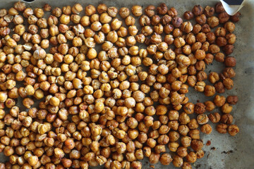 Sheet pan with homemade roasted chickpeas. Top view.