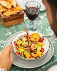 Businessman enjoying healthy salmon and shrimp salad for lunch