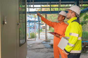 Electrical engineer man checking voltage at the Power Distribution Cabinet,preventive maintenance Yearly,Supervisor Working at a wastewater treatment plant