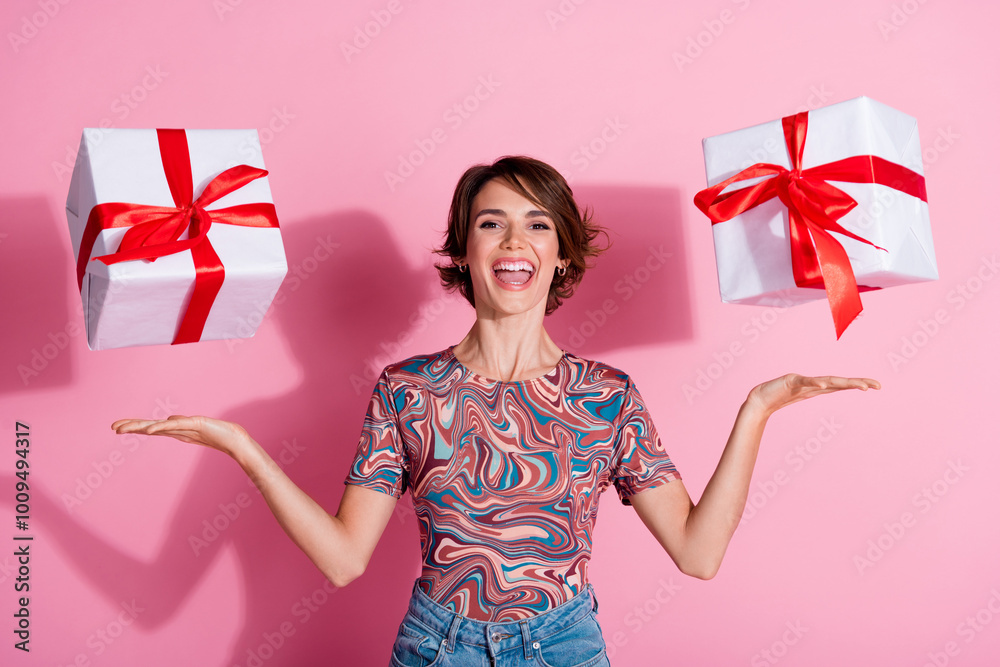 Poster Photo of adorable cheerful lovely girl wear stylish clothes hands hold gift isolated on pink color background