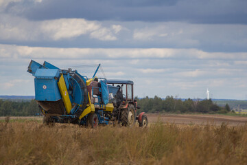 Farm machinery harvesting potatoes on farm field © Bagatela