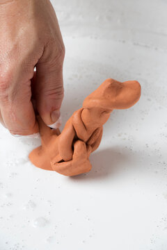 The hands of a craftswoman elaborating a traditional and ancestral figure of clay craftsmanship in Mallorca (Spain) called "siurell".