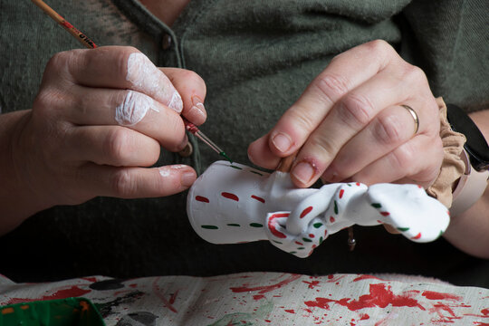 The hands of a craftswoman elaborating a traditional and ancestral figure of clay craftsmanship in Mallorca (Spain) called "siurell".