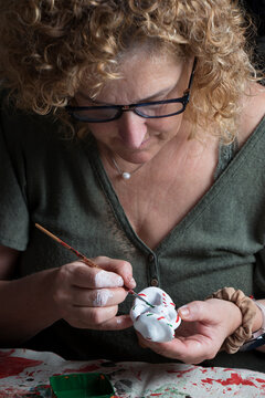 Craftswoman making a traditional figure of ancestral origin, called "siurell", typical of the handicrafts of the island of Mallorca (Spain).