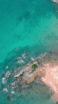 Aerial View of Waves Crashing on Rocky Beach
