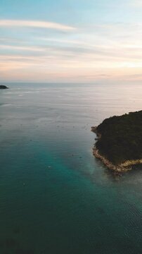 Vertical Video - Aerial panorama of Sunset Over Sea with Island Horizon
