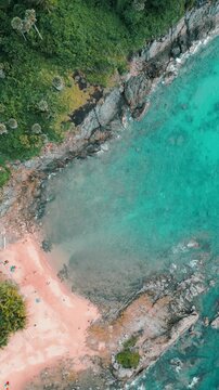 Vertical Video - Aerial view of  rocks and waves on a beautiful Island beach coastal