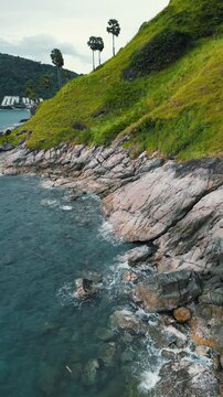 Vertical Video - Coast of the sea with greens and mountains