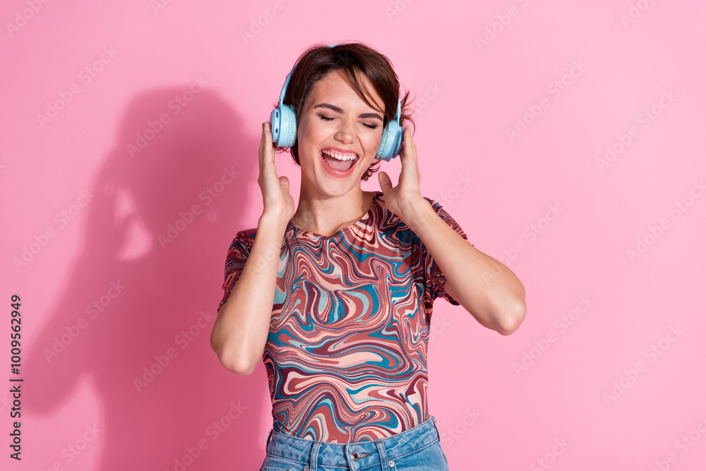 Sticker Photo of lovely cute cheerful girl wear stylish print clothes listen music isolated on pink color background