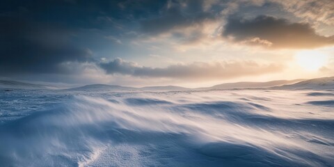 Obraz premium A serene winter landscape with gentle snow drifts and a dramatic sky at sunset.