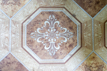 An elegant octagonal floral motif on a classic tiled floor