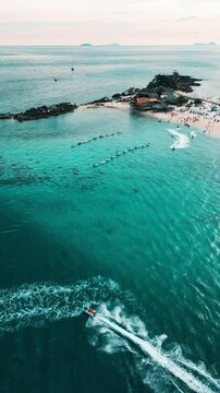 Vertical Video - Aerial Capture of Water Scooter Rides in Stunning Blue Waters
