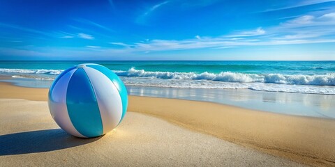 Obraz premium Vibrant Light Blue Beach Ball on Sandy Shore with Clear Blue Sky and Gentle Ocean Waves Background