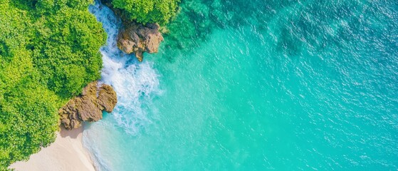  From above, a beach stretches out with a body of water on each side, framed by trees