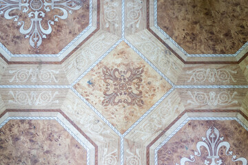 Elegant symmetry: ornamental geometric and floral patterns on a vintage floor