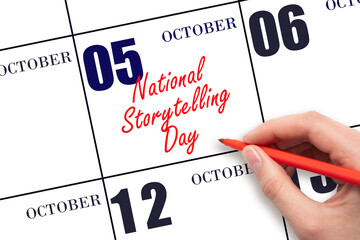 October 5. Hand writing text National Storytelling Day on calendar date. Save the date.