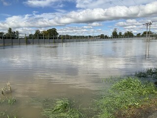 Flooded fields along impassable national road DK1 due to pool of water at confluence of Rivers...