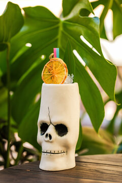 A cocktail in a tiki style skull glass