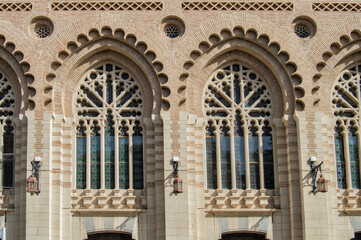Obraz premium Neo-Mudejar style brick lobed arch windows on the facade of the train station in Toledo. Spain