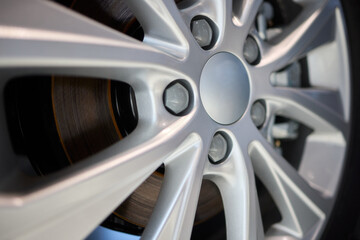 Detailed shot of a sleek black and silver alloy wheel on a motor vehicle