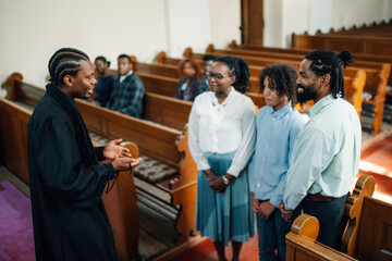 Priest talking to family after church service
