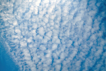 Wispy cirrus clouds stretch across the sky, creating ethereal patterns. Their delicate formations hint at fleeting moments and the beauty of nature's artistry