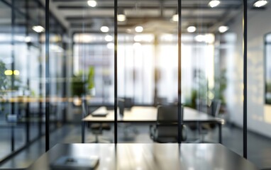 Blurred view of a modern office space with glass walls and bright lights. Business and workspace concept.