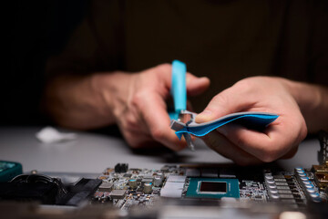 Hand Repairing a Graphics Card through the Application of Thermal Paste for Better Performance