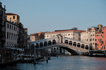 A city bridge over a river with buildings in the background