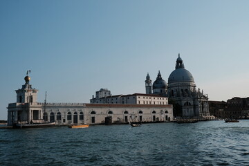 An impressive building sits majestically on a body of water