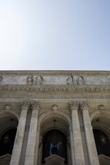Striking façade of the New York Public Library, featuring towering columns and elegant sculptures amidst the hustle of the bustling city