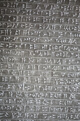 Intricate Sumero-Akkadian cuneiform inscriptions etched in clay, revealing stories of ancient civilizations and their contributions to writing and record-keeping