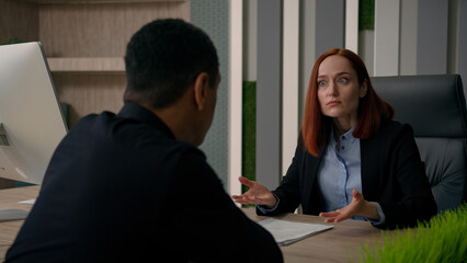 Two multiracial businesswoman and businessman work with computer business online project Caucasian woman consult African American man client customer service at office help with offer bank insurance