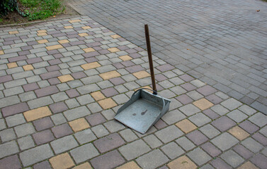 Dustpan on the ground. Environmental care. Cleaning up fallen leaves and debris. 