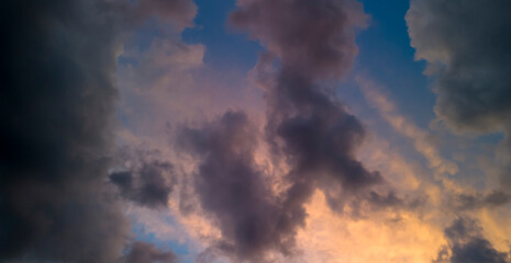 Stunning clouds at sunset create a dramatic skyline with vibrant colors and intricate patterns....