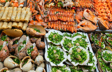Delicious Asian cuisine, food at the night market. Traditional street food from various seafood delicacies. Unusual food for tourists.