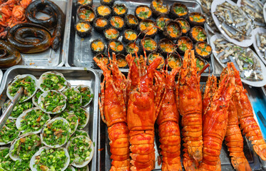 Delicious Asian cuisine, food at the night market. Traditional street food from various seafood delicacies. Unusual food for tourists.