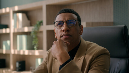 Close up thoughtful male businessman puzzled ethnic man think difficult question business problem solution at office workplace pensive employer manager CEO thinking ponder deep thoughts consider doubt