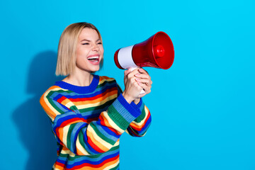 Profile photo of nice young woman communicate loudspeaker wear striped sweater isolated on blue color background