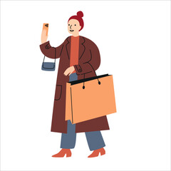 Woman dressed in trench coat holding shopping bags. Shopping with a smartphone. Winter and Christmas sale.
