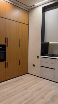 Elegant Modern Kitchen and Living Room Interior with Sleek Built-in Cabinets and Open-Plan Design. High quality video 4K