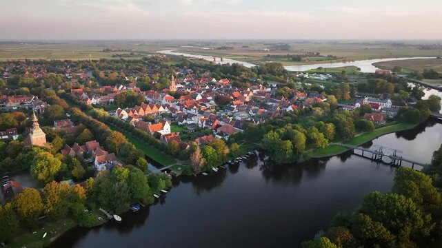 Aerial footage of Friedrichstadt, Dutch town in the state Schleswig-Holstein with the romantic canals situated on the river Eider and Treene, Nord frisia, Germany. Fligth over Westersielzug.