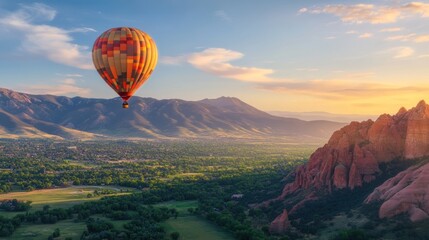 Hot Air Balloon Soaring Over Majestic Mountain Range at Sunset